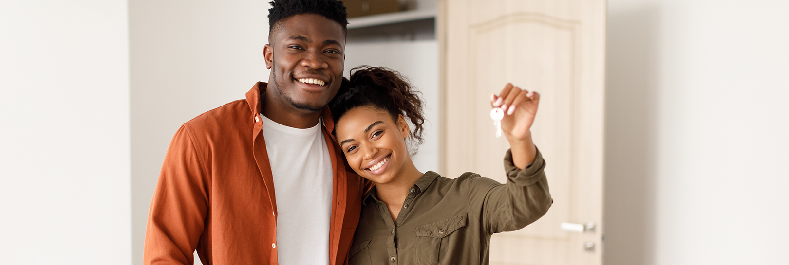 Couple with keys to their new house